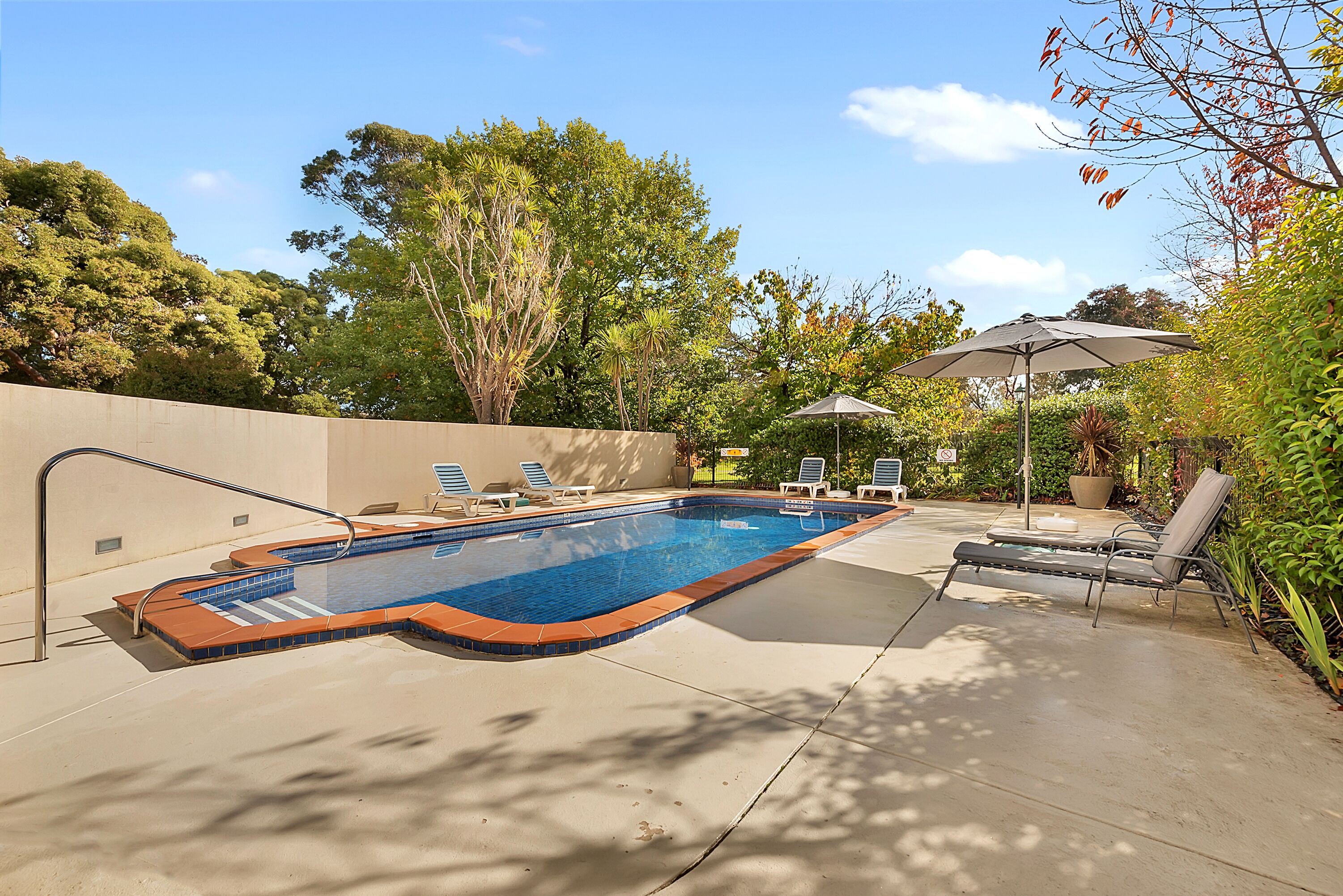 outdoor pool, pool umbrellas, pool loungers