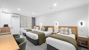 A hotel room with two beds, a desk, and a chair. - Beechworth Motor Inn (Beechworth)