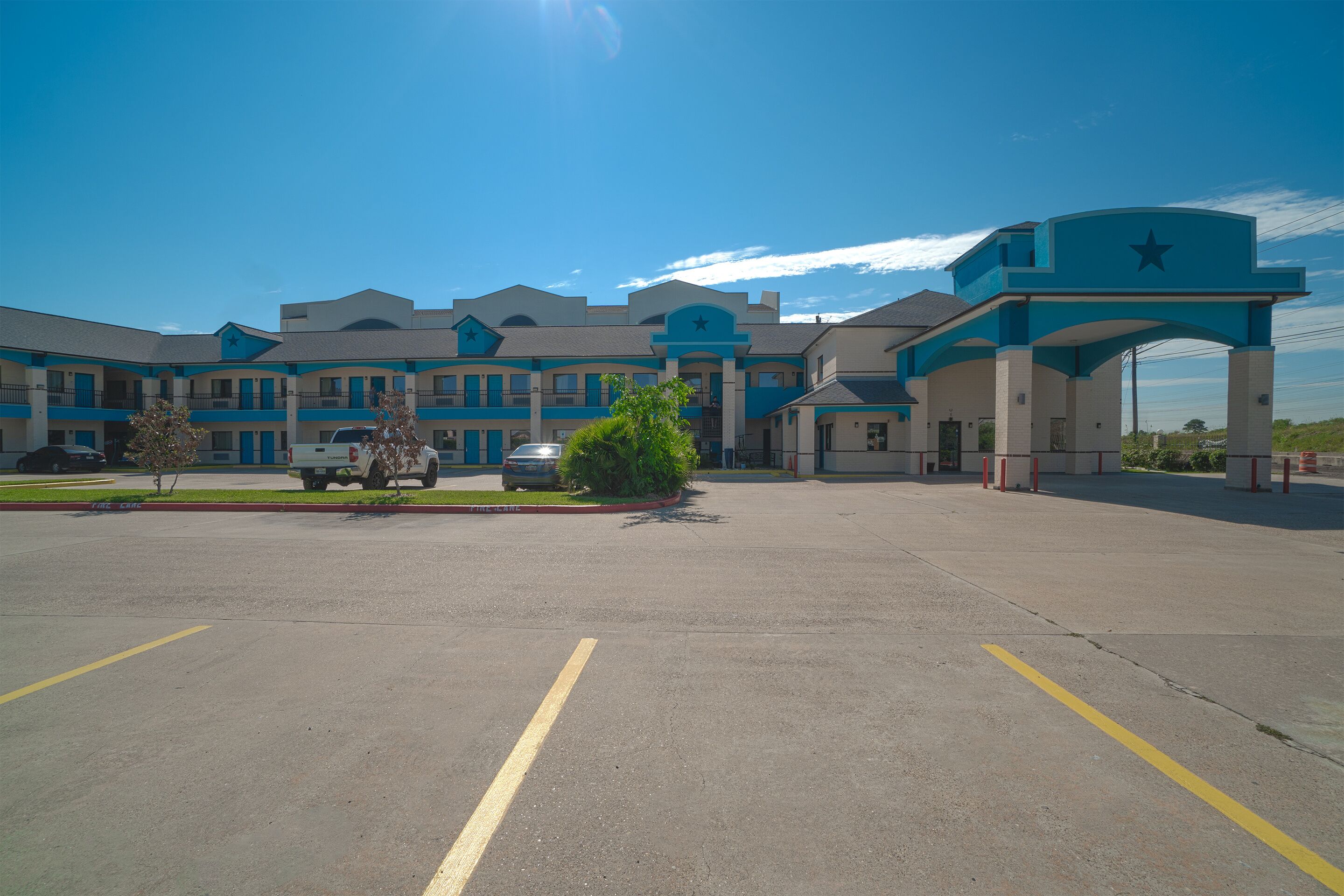 A large building with a blue and beige color scheme, featuring a prominent entrance with a star symbol.