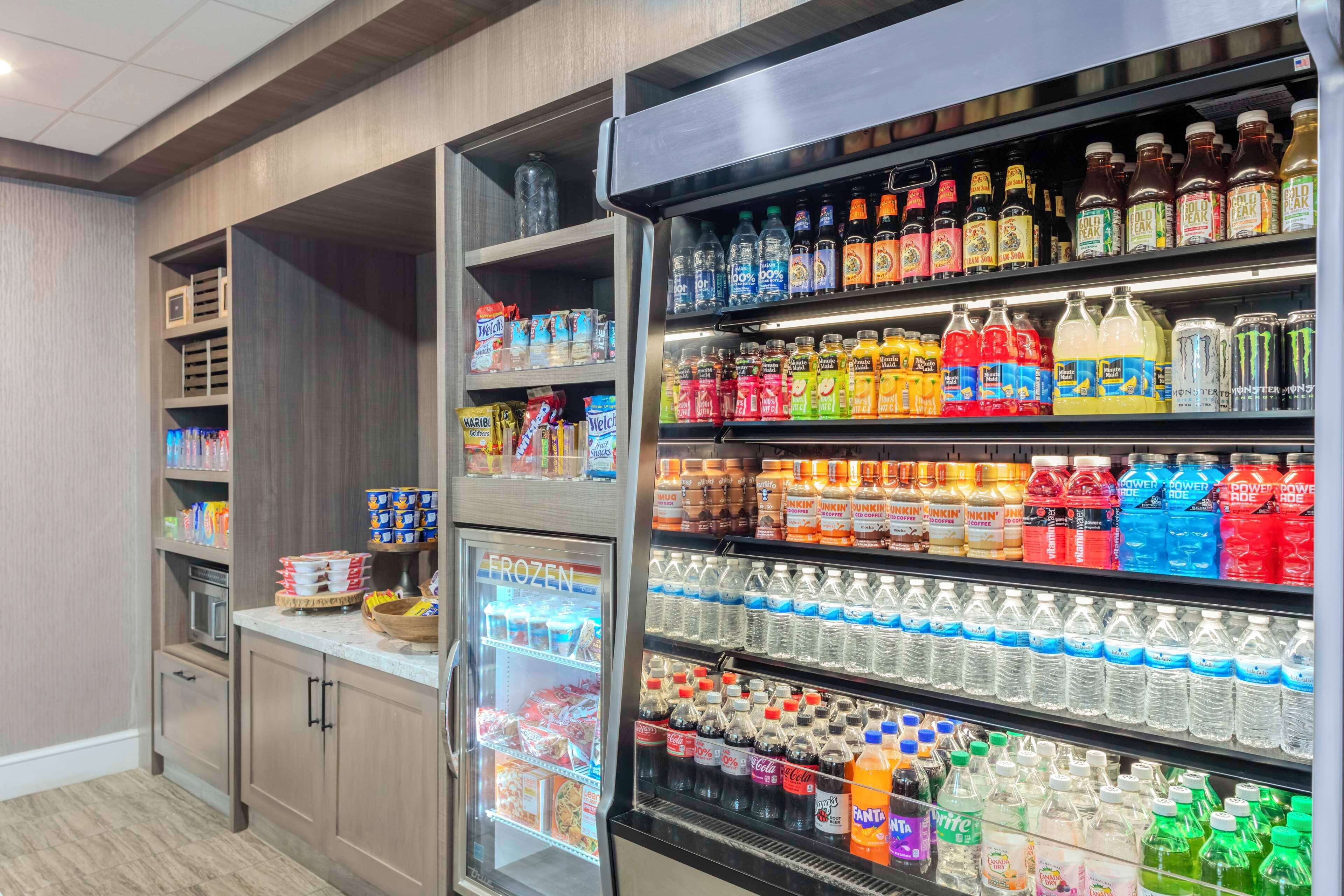 Un refrigerador bien surtido con diversas bebidas y aperitivos.