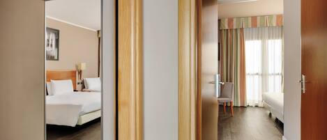 A hotel room with a bed, a chair, and a desk.