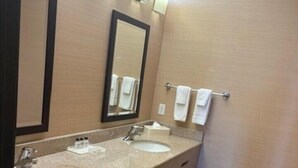 A bathroom with two sinks, a large mirror, and a towel rack.