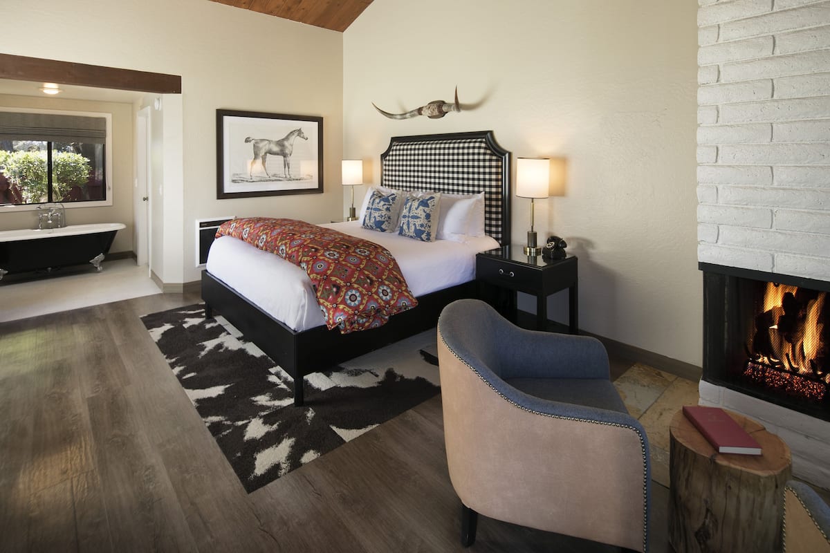 Deluxe Room, 1 King Bed, Fireplace | 1 bedroom, in-room safe, desk, iron/ironing board