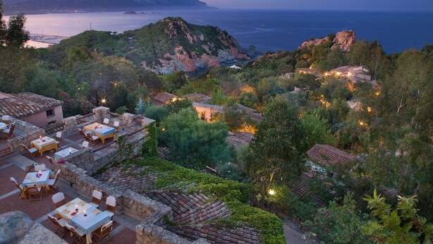 A coastal resort with outdoor seating areas, stone pathways, and buildings with terracotta roofs. - Hotel Monte Turri by Falkensteiner (Tortoli)