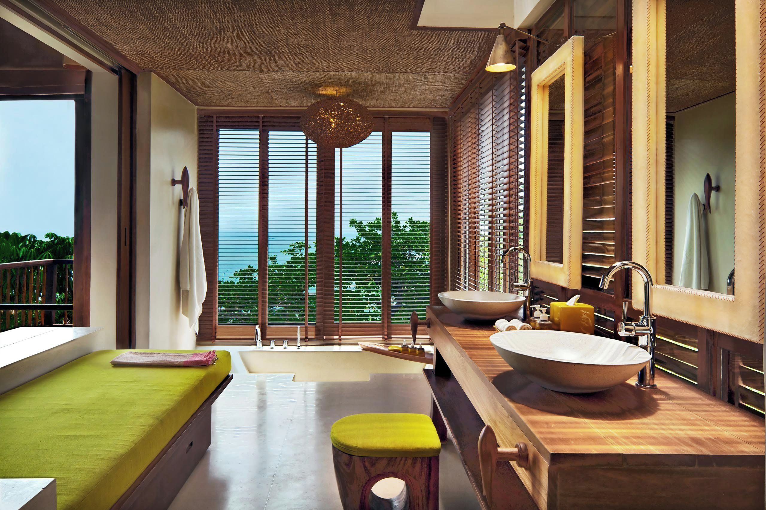 A modern bathroom with a large window, a bathtub, a sink, and a mirror.