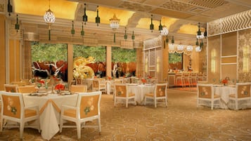 A spacious dining area with multiple tables and chairs, ornate ceiling decorations, and a large decorative dragon sculpture.