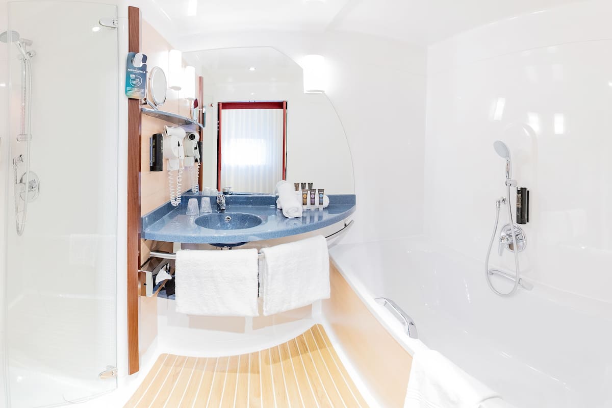 separate bathtub and shower, eco-friendly toiletries, hair dryer, towels