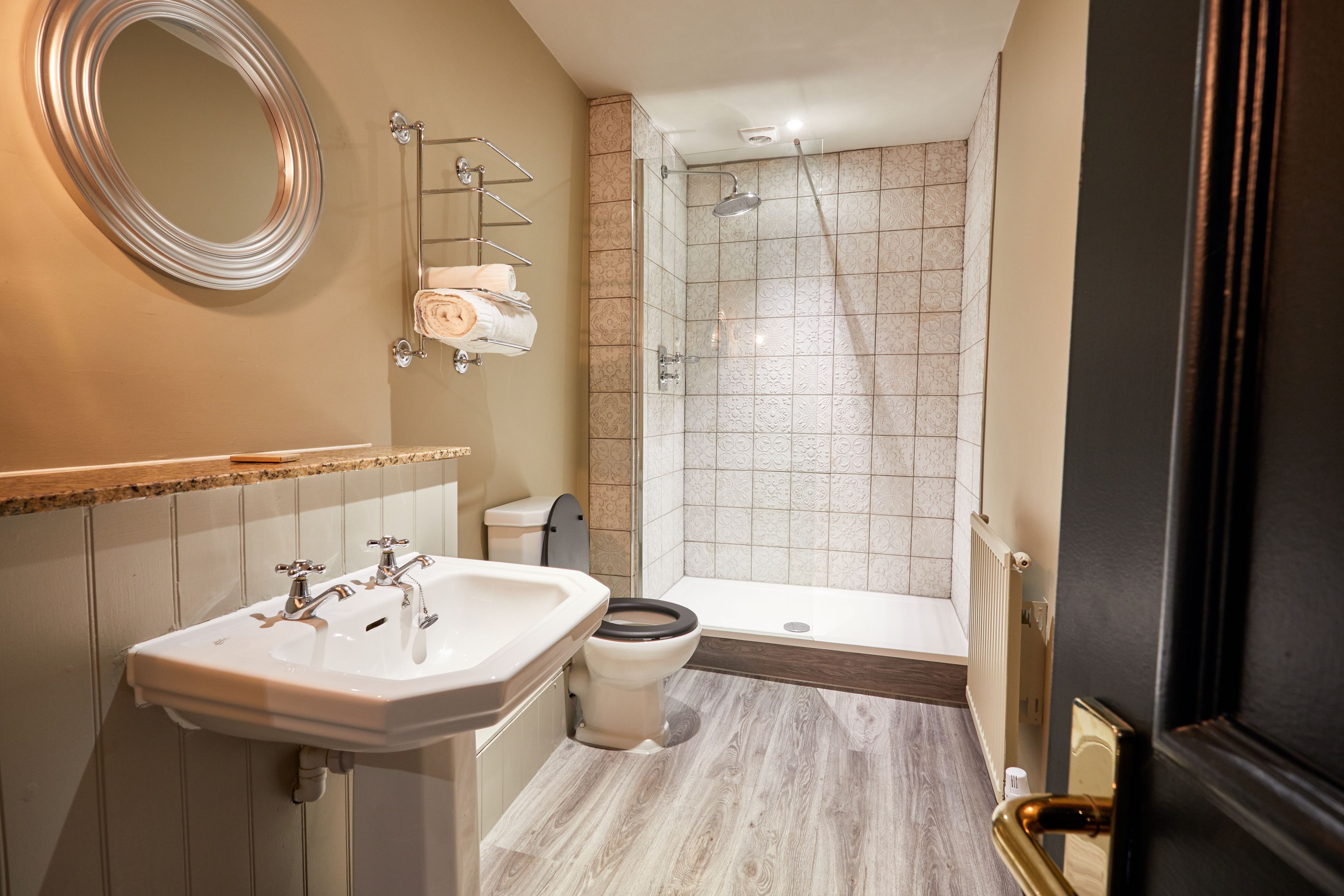 A bathroom with a sink, toilet, and shower.