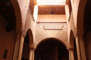 An interior view of a building with arches and a patterned ceiling. - Kasbah Le Mirage (Marrakech)