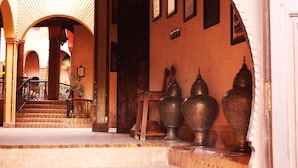 A staircase leading to a room with a tiled floor and a wooden railing. - Kasbah Le Mirage (Marrakech)