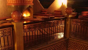 A multi-level building with a balcony, decorative railings, and a dome structure. - Kasbah Le Mirage (Marrakech)