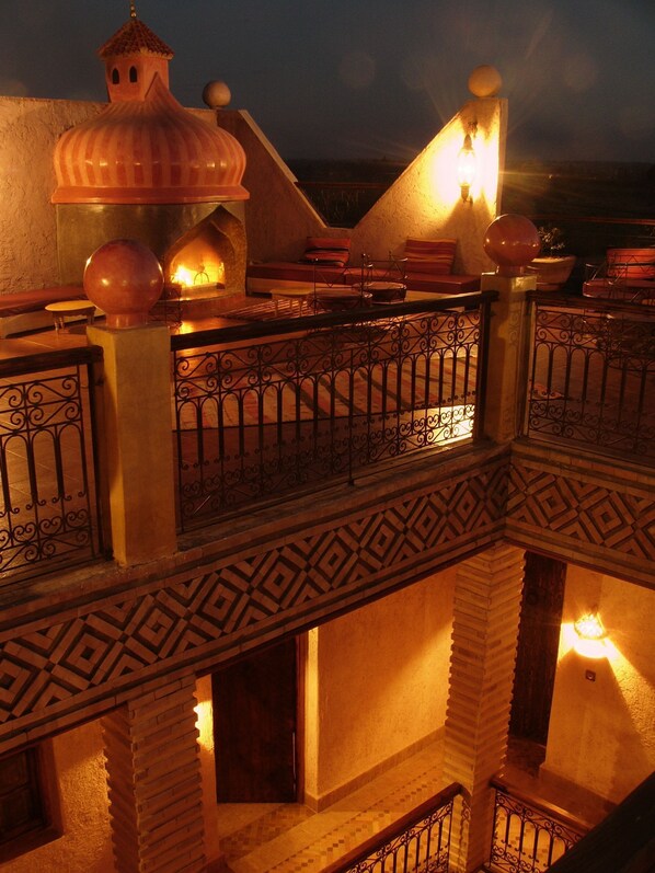 A multi-level building with a balcony, decorative railings, and a dome structure. - Kasbah Le Mirage (Marrakech)