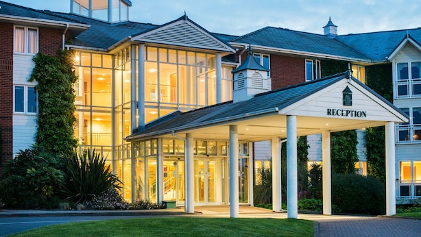 A hotel with a reception area, large glass windows, and a covered entrance. - The Arden Hotel & Leisure Club (Solihull)
