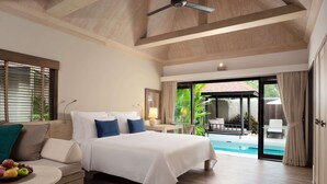 A spacious bedroom with a large bed, a wooden ceiling, and a view of a swimming pool. - Wyndham Hua Hin Pranburi Resort & Villas (Pranburi)