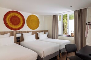 A hotel room with two beds, a desk, a chair, and a large window with curtains. - Korner Montmartre (Paris)