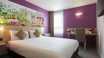 A hotel room with a bed, a desk, a chair, a painting, and a television.