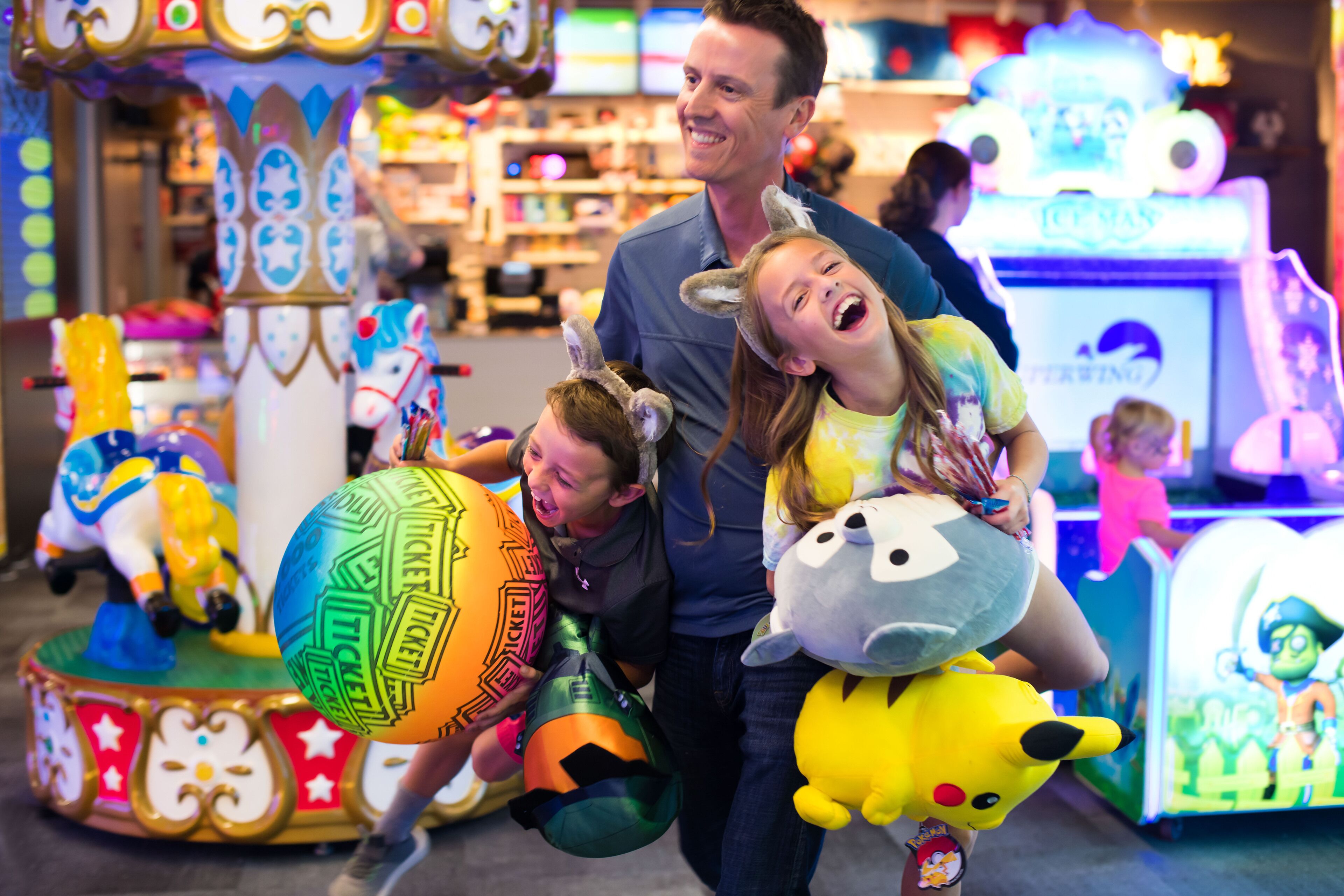 A carousel with colorful animal figures and a ticket booth.