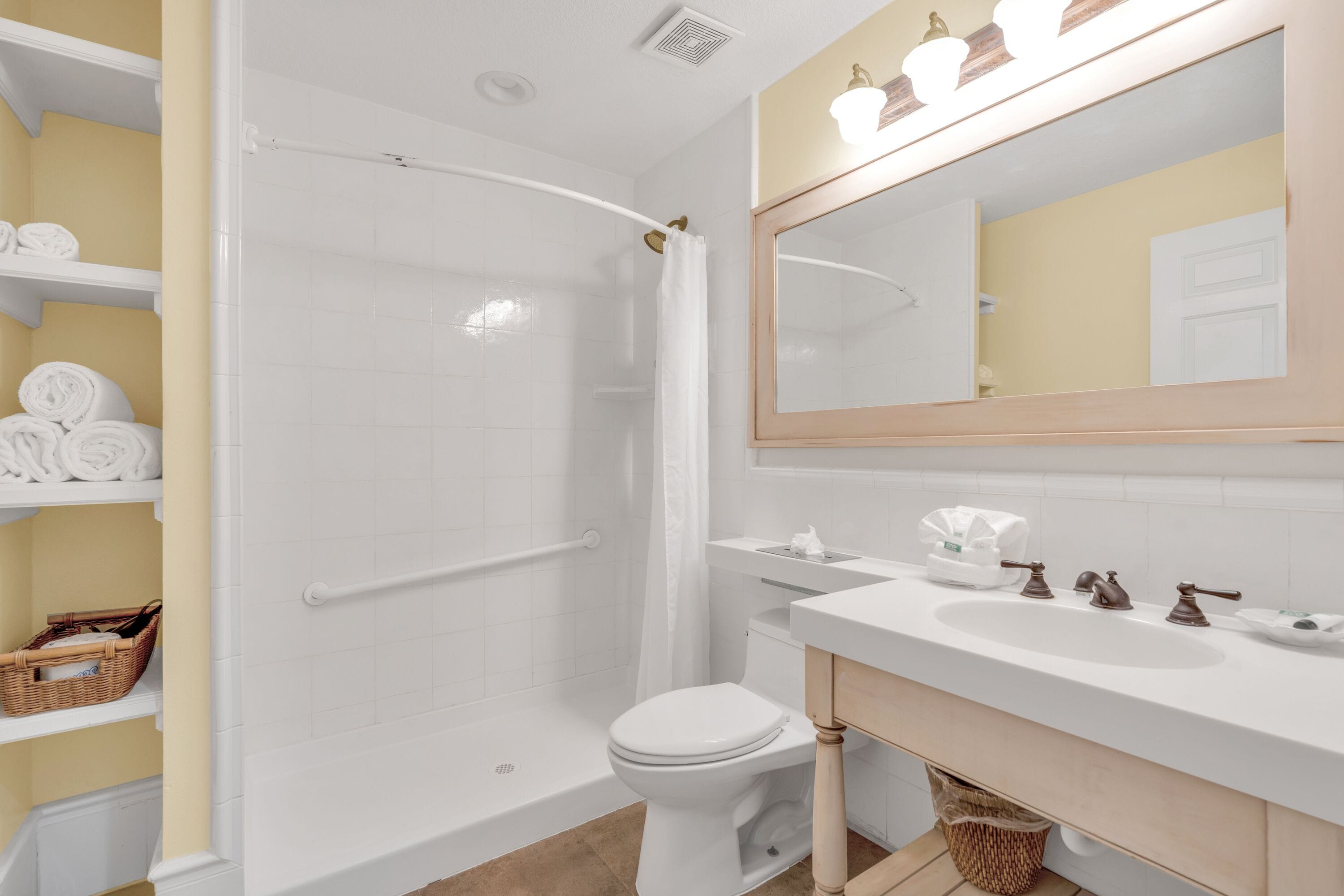 A bathroom with a white bathtub, a toilet, a sink, and a mirror.