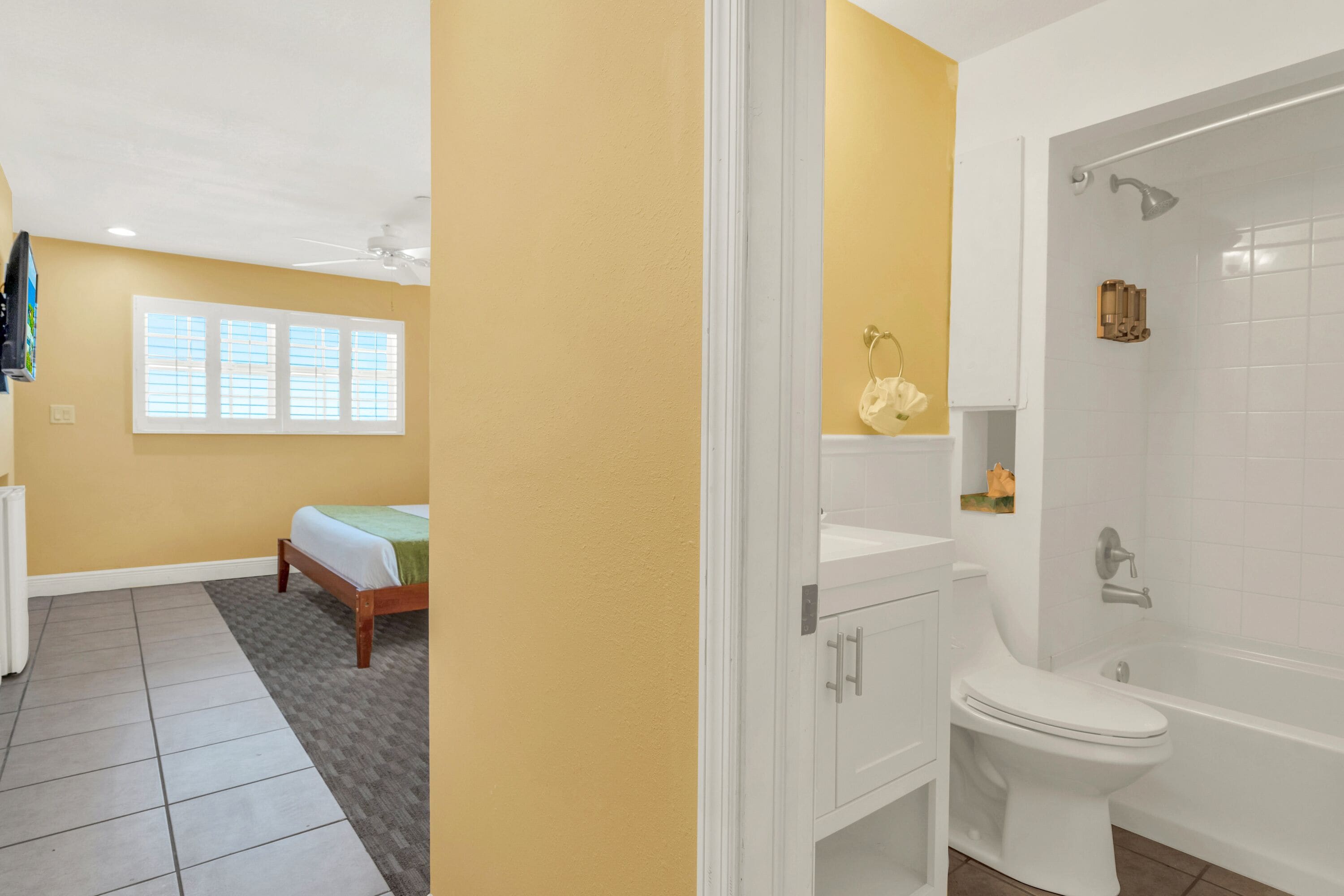 A bathroom with a bathtub, toilet, and sink.