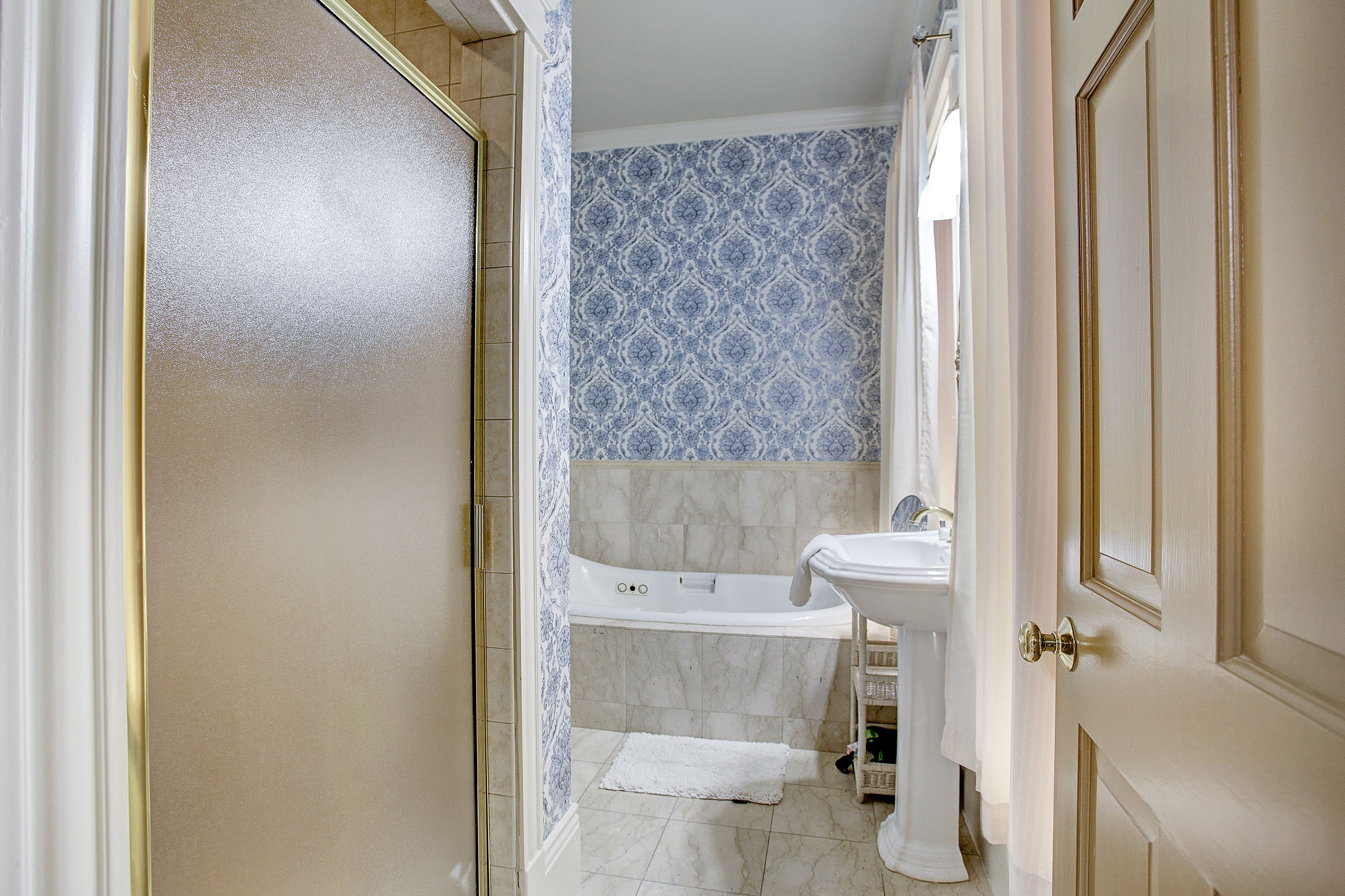 A bathroom with a bathtub, a sink, and a toilet.