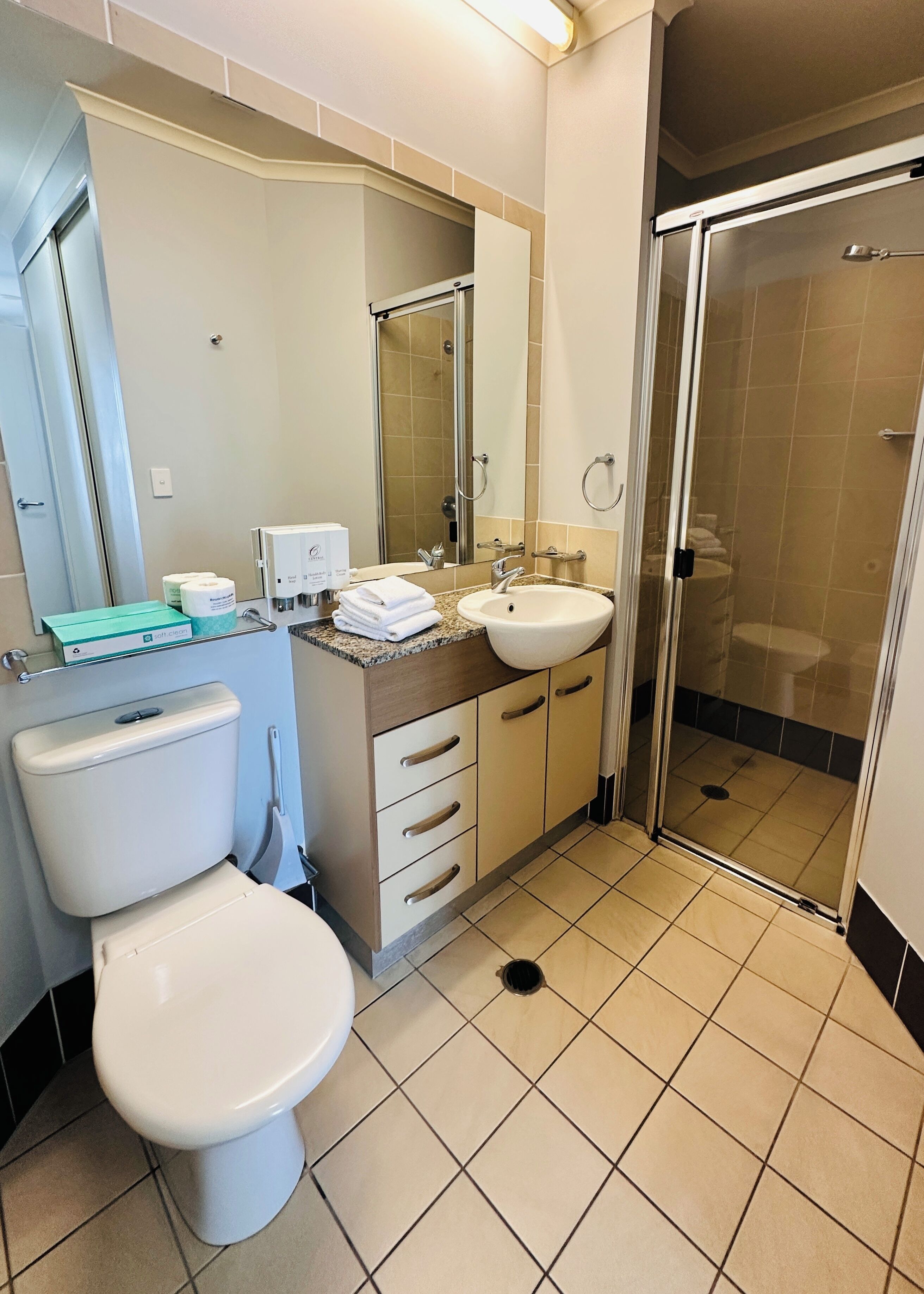 A bathroom with a toilet, sink, and shower.