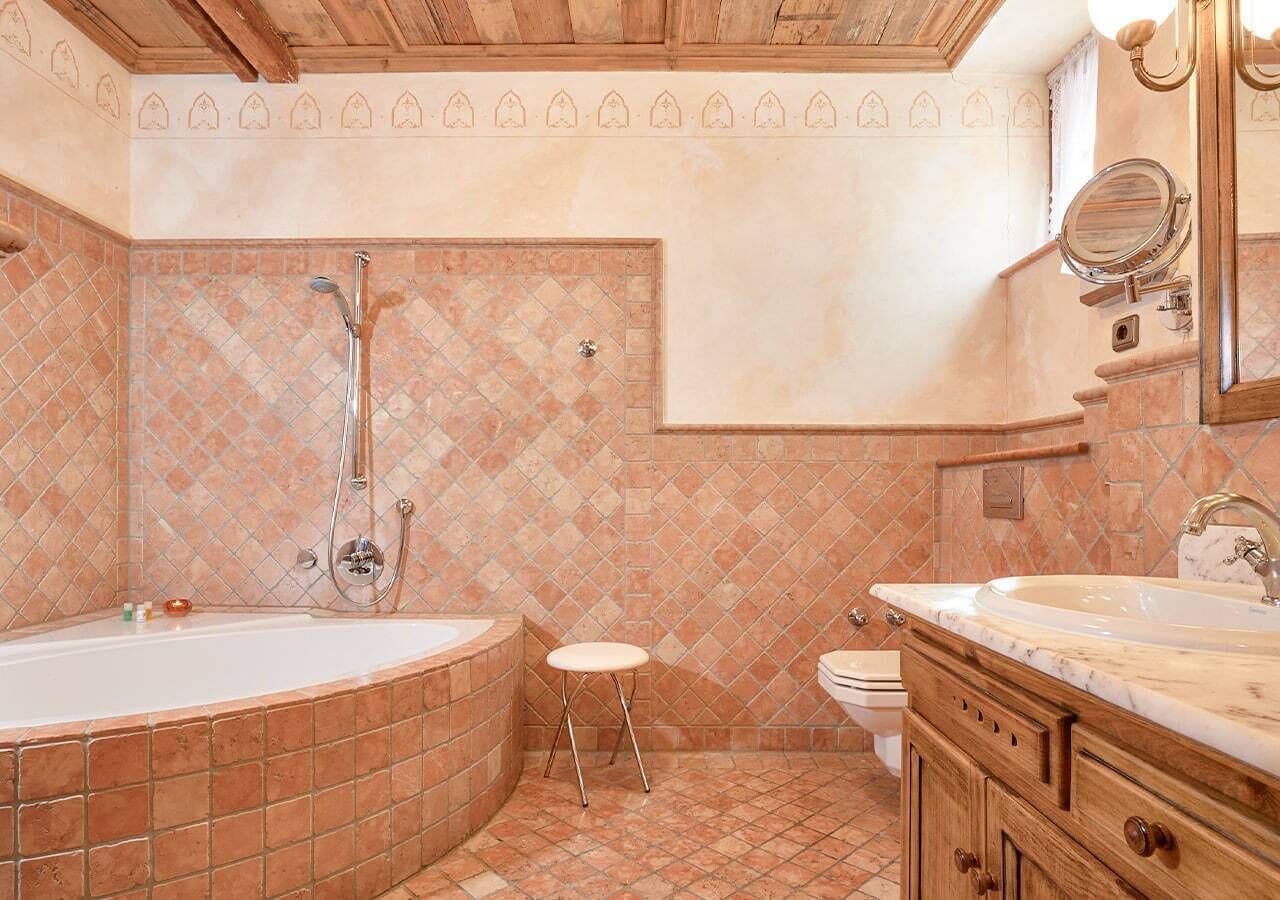 deluxe room (explorer) | bathroom | hair dryer, slippers, towels