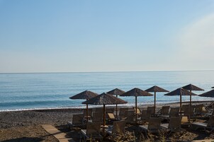 Private beach, black sand, sun loungers, beach umbrellas