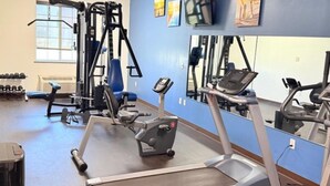 A gym with cardio equipment, dumbbells, and a mirror. - Hawthorn Extended Stay by Wyndham Amarillo (Amarillo)
