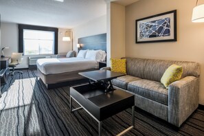 A hotel room with a bed, a sofa, a desk, and a window. - Holiday Inn Express Hotel & Suites Livermore by IHG (Livermore)