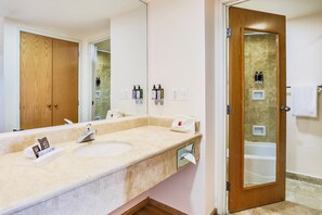 A bathroom with a sink, mirror, and a shower area. - Fiesta Inn Torreon Galerias (Torreón)