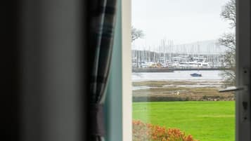 Apartment, 2 Bedrooms, Sea View | Desk, blackout drapes, iron/ironing board, travel crib