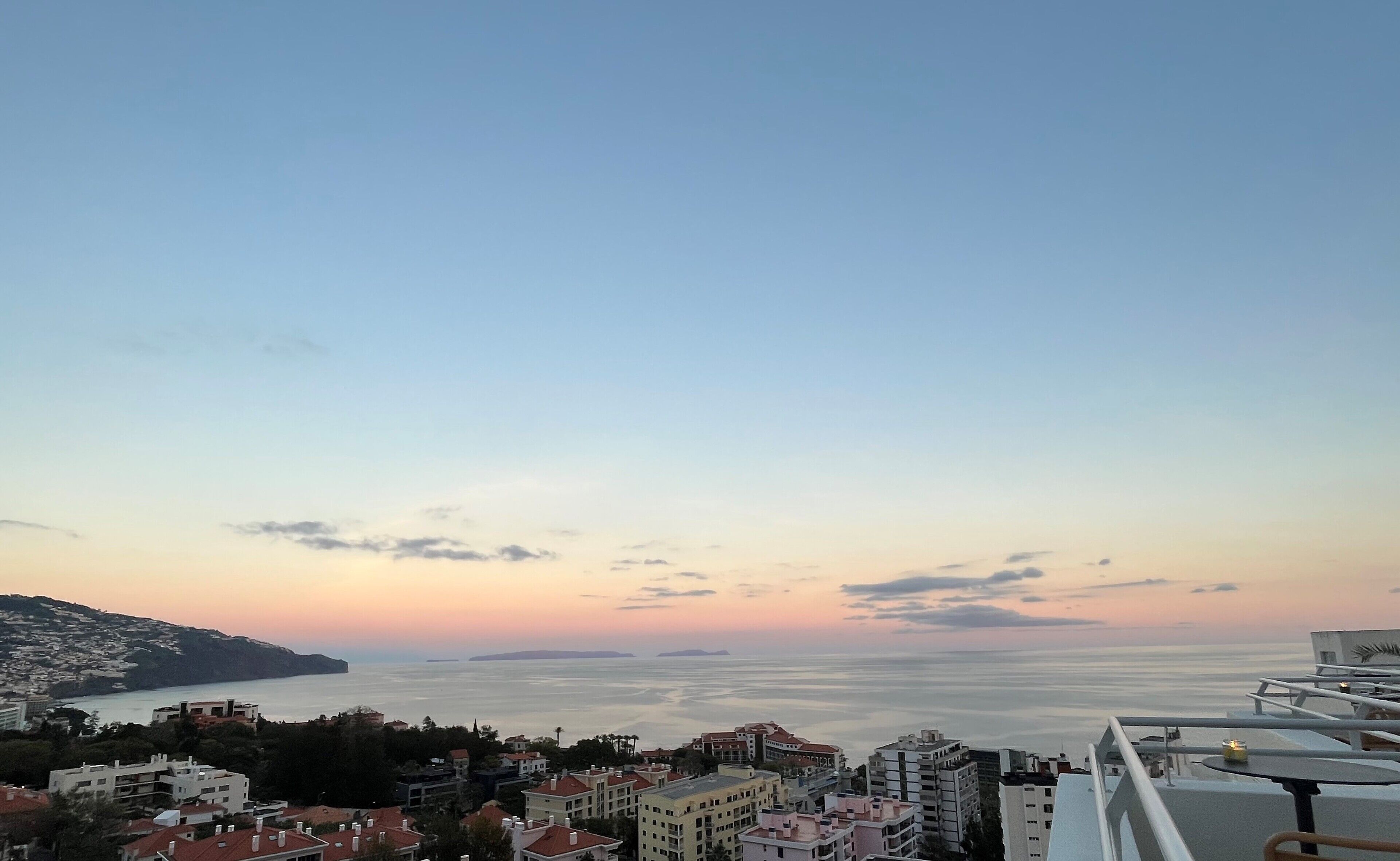 A coastal cityscape with buildings overlooking the sea.