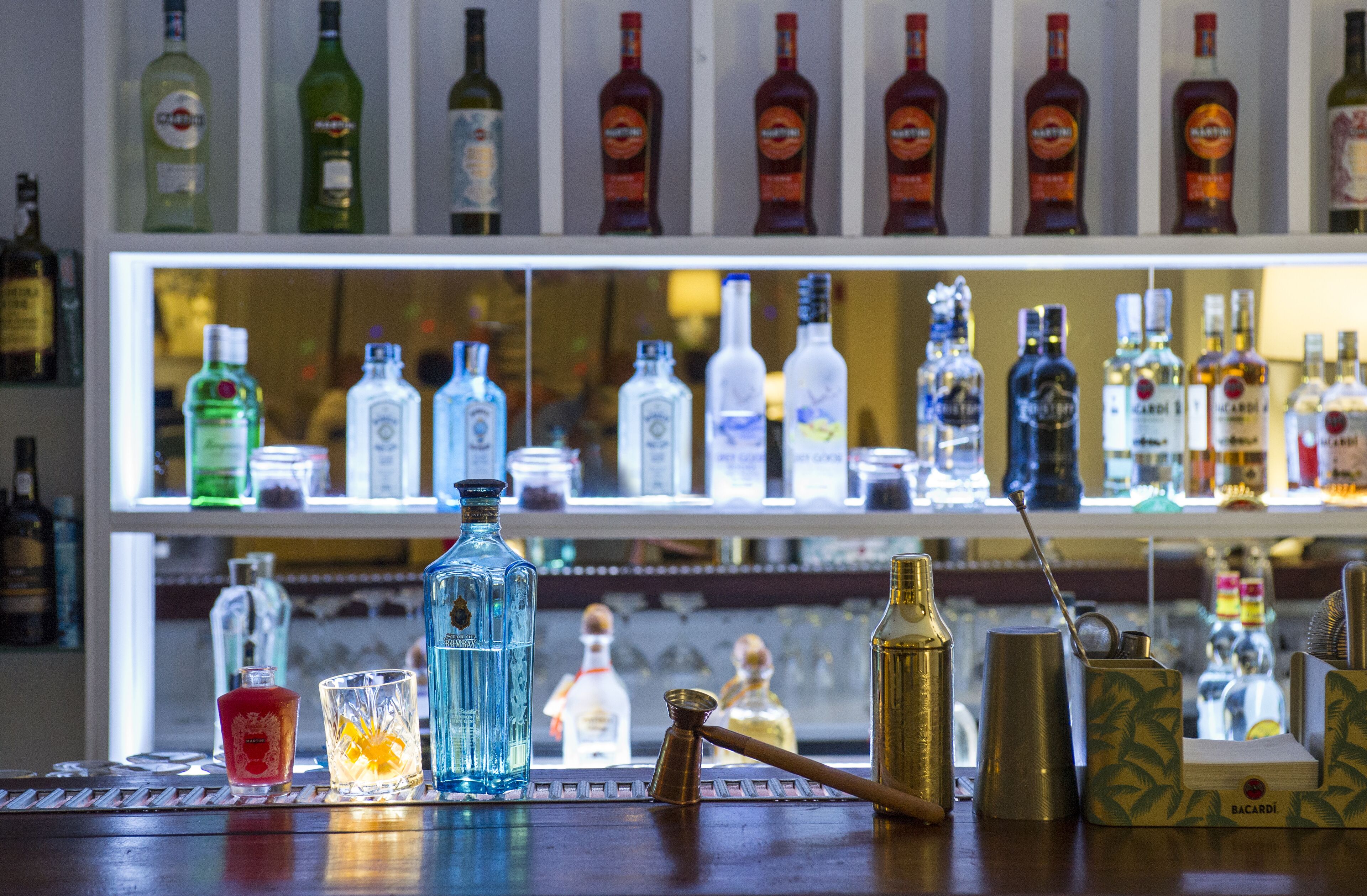 A bar area with various liquor bottles and bar tools.