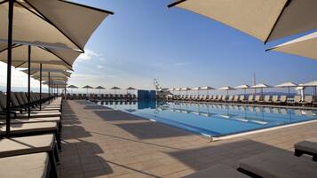 Relax by the pool with comfortable sun loungers and umbrellas.