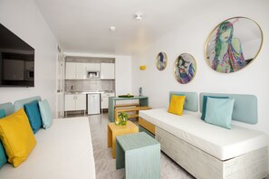 A modern apartment with a living area, kitchen, and dining space. - Sotavento Club Apartments - Only Adults (Calvia)