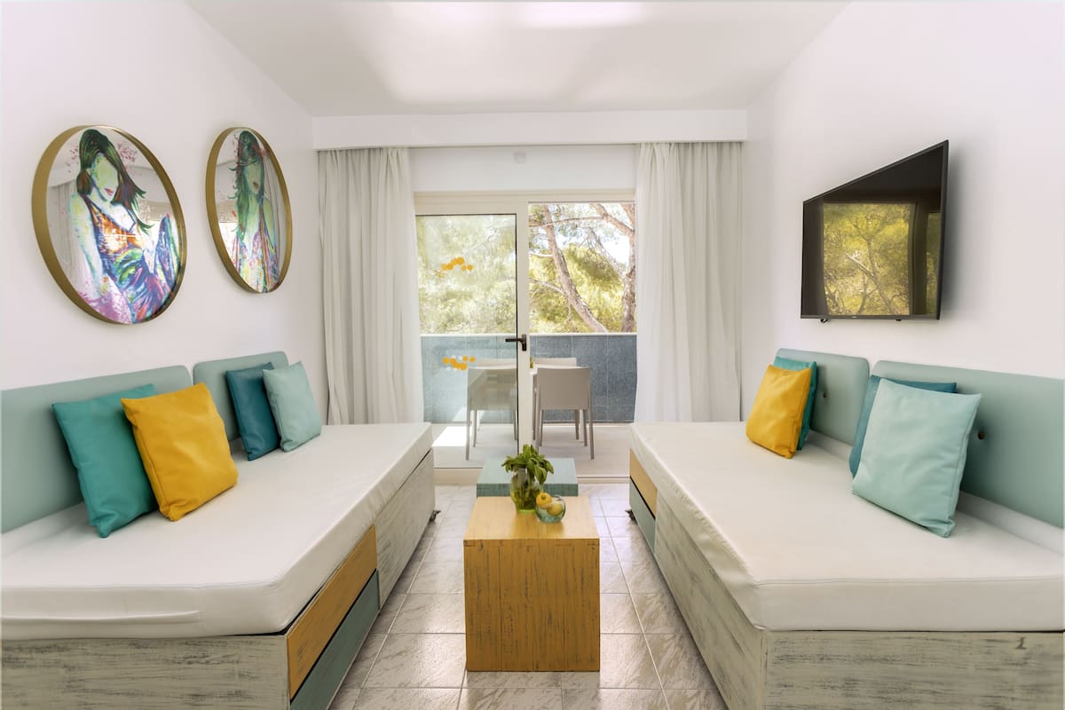A modern living room with two sofas, a coffee table, and artwork on the walls.