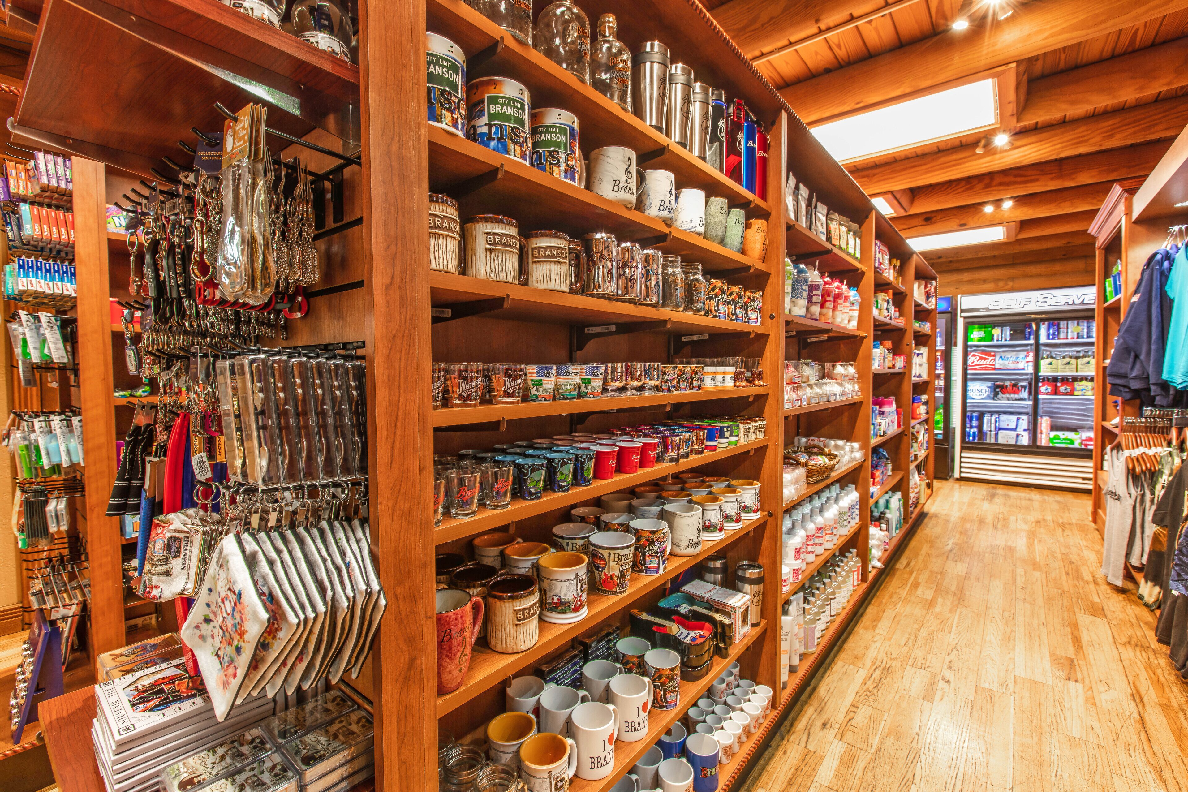A store with wooden shelves stocked with various items like mugs, jars, and bags.