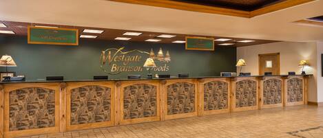 A reception desk with a sign for VIP check-in and guest registration.