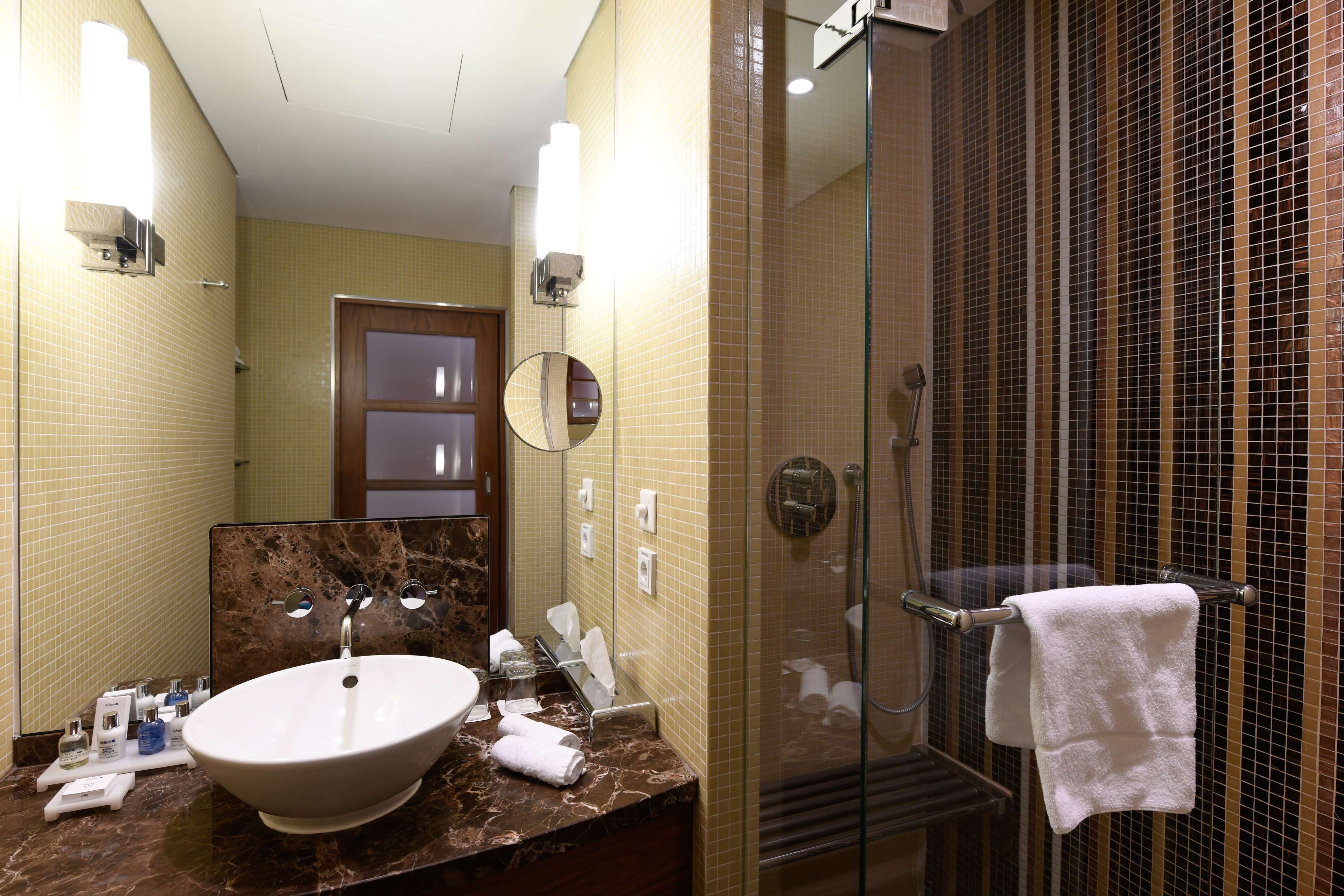 superior room | bathroom | rainfall showerhead, designer toiletries, hair dryer, towels