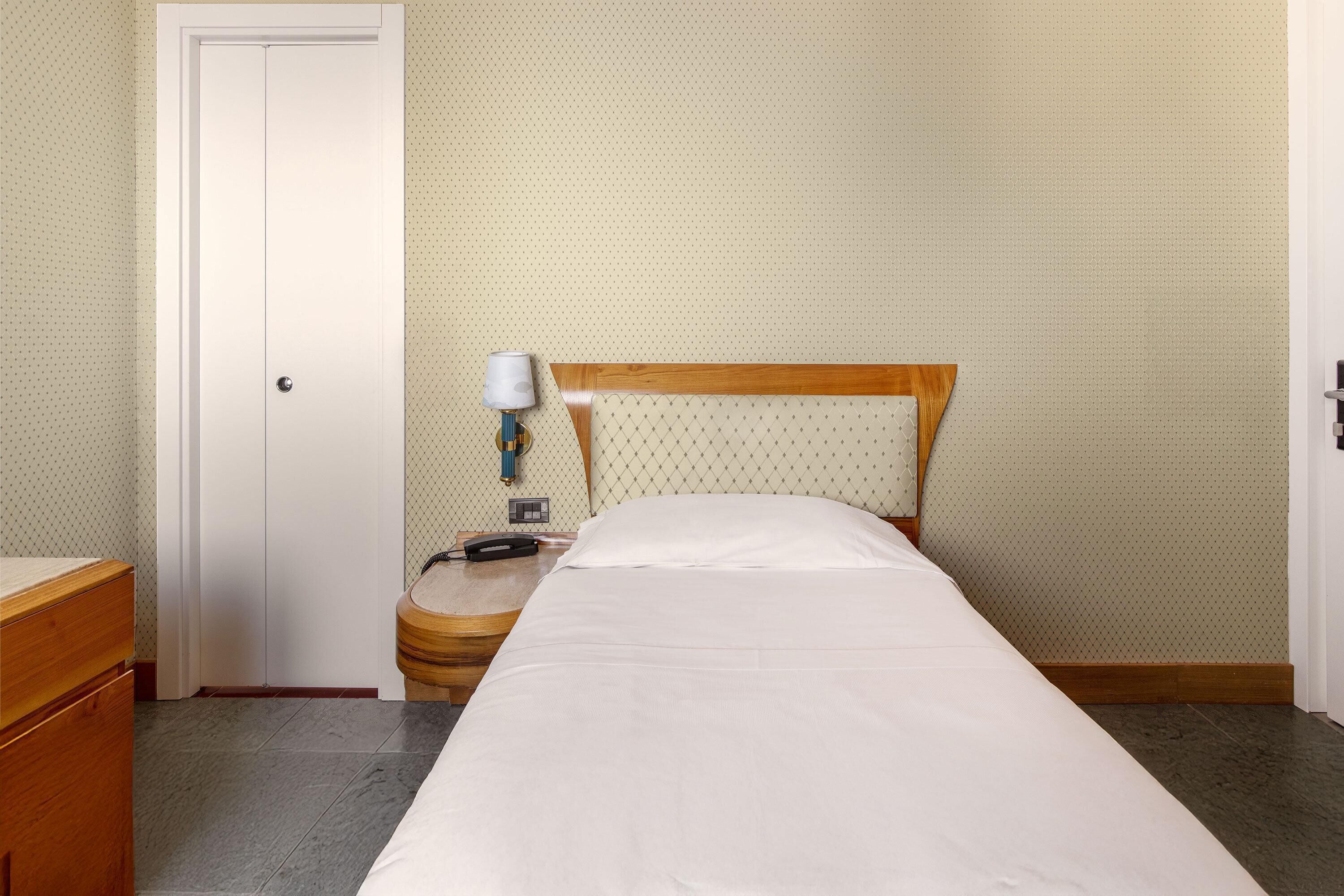 Economy Single Room, Non Smoking | Minibar, in-room safe, desk, blackout drapes