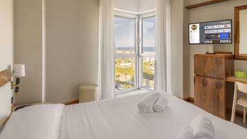 Standard Quadruple Room, Non Smoking, Beach View | Minibar, in-room safe, desk, blackout drapes