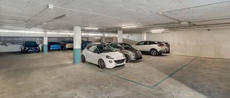 A multi-level parking garage with several cars parked.