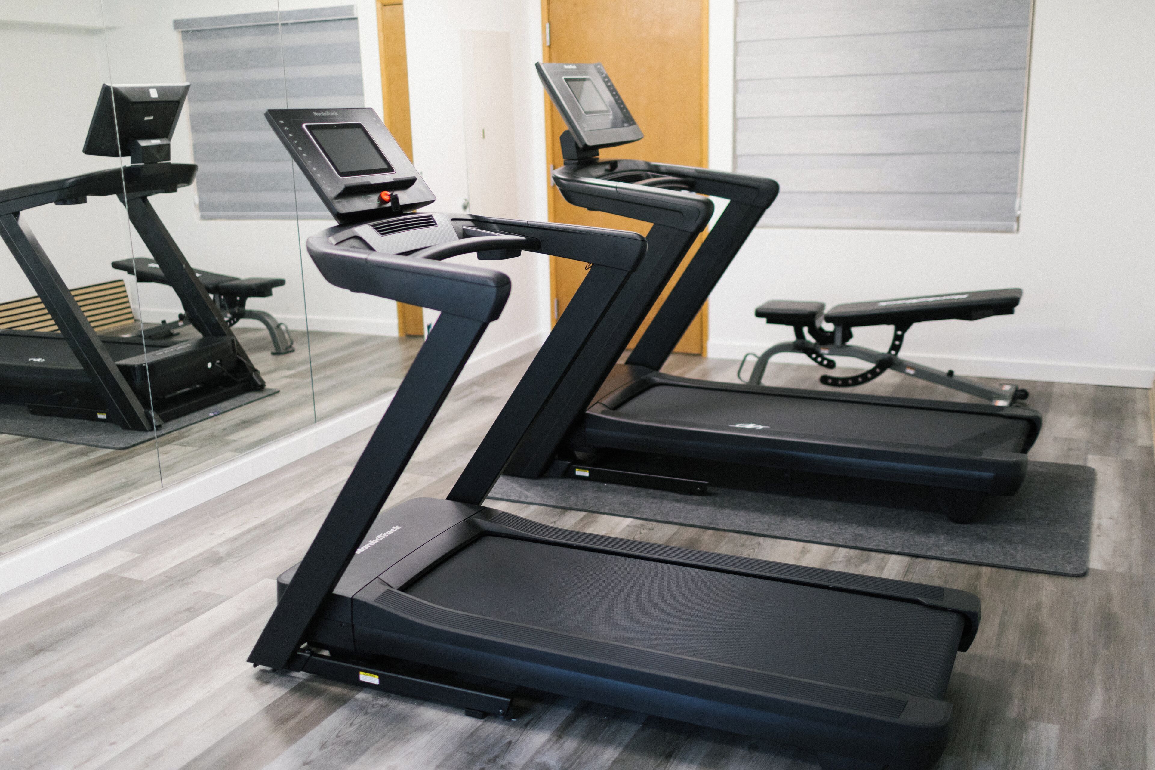 A gym with treadmills and a stationary bike.