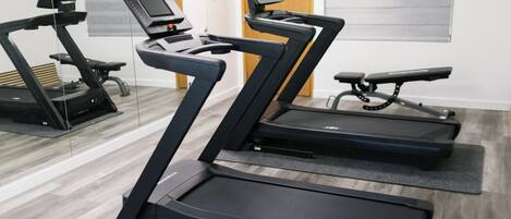 A gym with treadmills and a stationary bike.