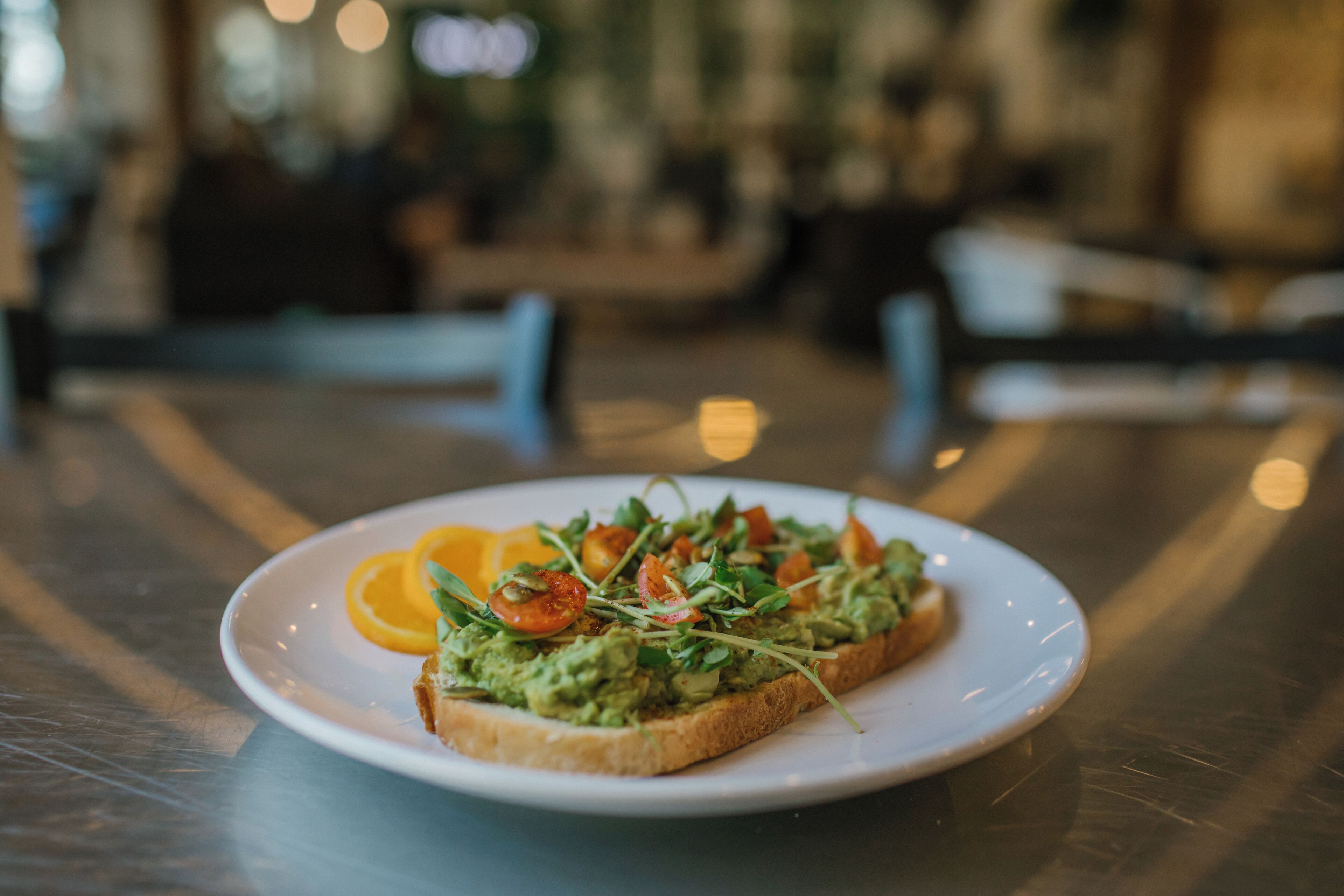 A plate with a sandwich on a table.