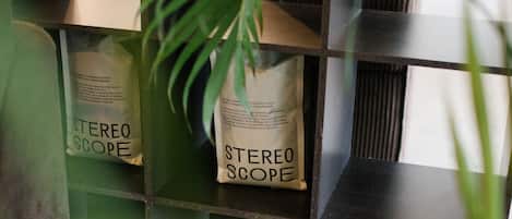 A shelf with bags labeled "STEREO SCOPE" and a potted plant.