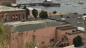 A marina with boats, a dock, and buildings in the foreground. - Palace Hotel Port Townsend (Port Townsend)