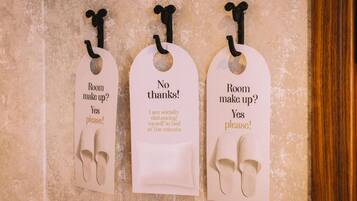 Three tags with different messages on a textured wall.