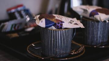 Two striped cups with coffee pods on a tray.