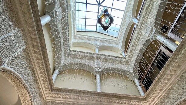 A spacious atrium with ornate arches, a central fountain, and a skylight. - Alcoba del Rey de Sevilla Boutique Hotel (Seville)
